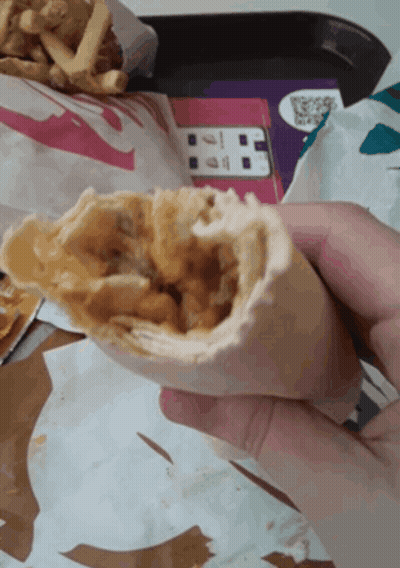 Person Holding Taco With French Fries GIF