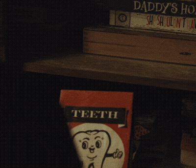 Person Holding Teeth Book With Tooth GIF