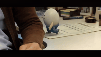 Person Holding Toy With Letter L On Back GIF