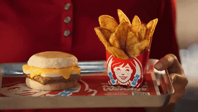 Person Holding Tray With Wendy's Breakfast Sandwich And French Fries GIF