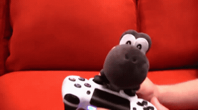 Person Holding Video Game Controller With Stuffed Animal GIF