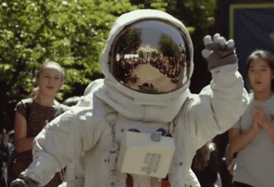 Person In Astronaut Suit Waving GIF