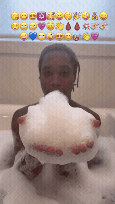 Person In Bathtub Holding Soap Bubble With Emoji Faces GIF