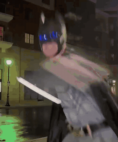 Person In Batman Costume Holding Sword GIF