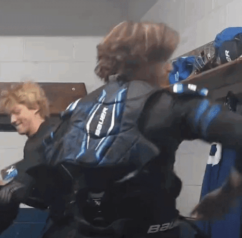 Person In Bauer Shoulder Pads In Locker Room GIF