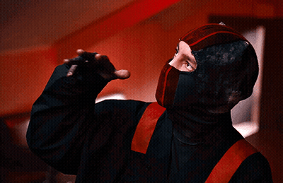 Person In Black And Red Costume With Red Belt GIF