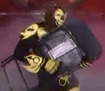 Person In Black And Yellow Costume Holding Black Object GIF