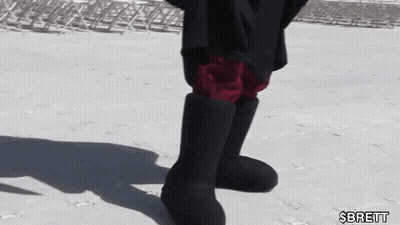 Person In Black Boots And Red Shorts Standing In Snow GIF