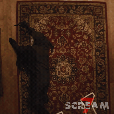 Person In Black Costume Crawling On Scream Rug GIF