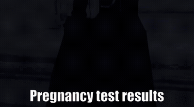 Person In Black Dress In Front Of Pregnancy Test Results Sign GIF
