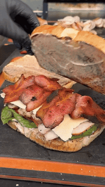 Person In Black Gloves Cutting Sandwich GIF