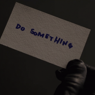 Person In Black Gloves Holding No Swifting Sign GIF