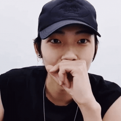 Person In Black Hat Covering Mouth GIF