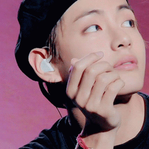 Person In Black Hat With Earbuds GIF
