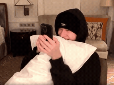 Person In Black Hoodie Holding Phone GIF