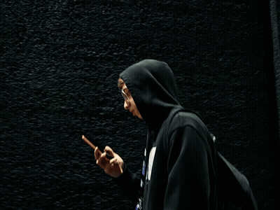 Person In Black Hoodie Talking On Phone GIF