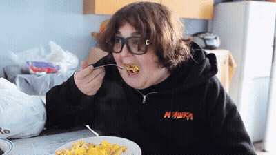 Person In Black Mishka Sweatshirt Eating GIF