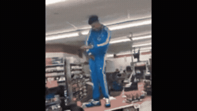 Person In Blue Adidas Tracksuit On Shoe Display GIF
