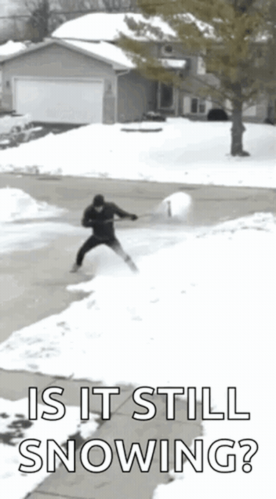 Person in Blue Coat Walking Through Snow