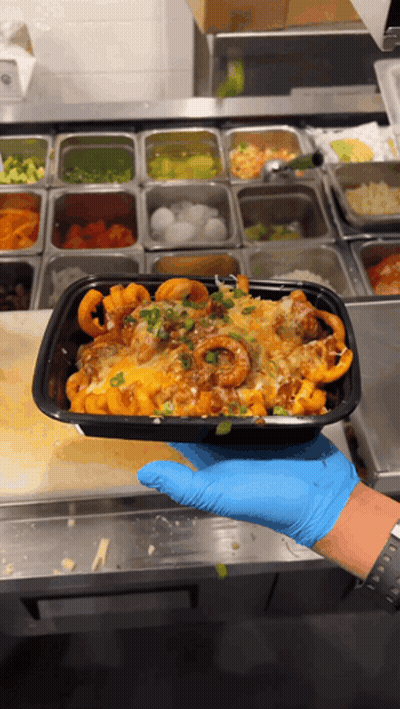 Person In Blue Gloves Holding Black Food Container GIF