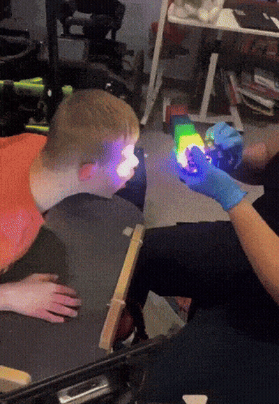 Person In Blue Gloves Holding Toy GIF