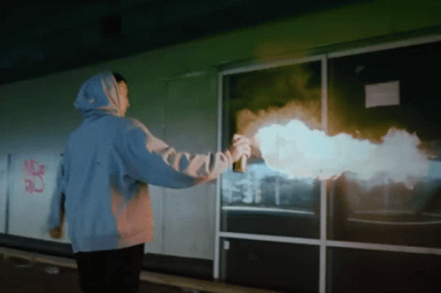 Person In Blue Hoodie Spray Painting Building GIF