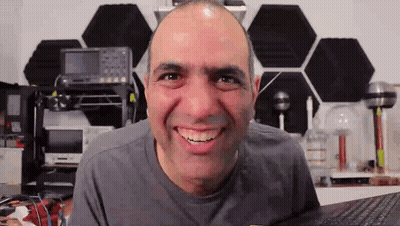 Person In Blue Hoodie Surrounded By Glowing Lights GIF