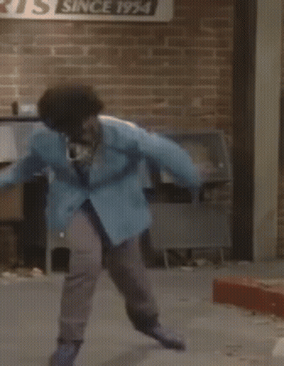 Person In Blue Jacket Jumping Near Mailbox GIF