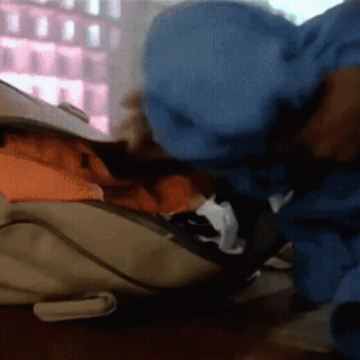 Person In Blue Jacket Looking Into Backpack GIF