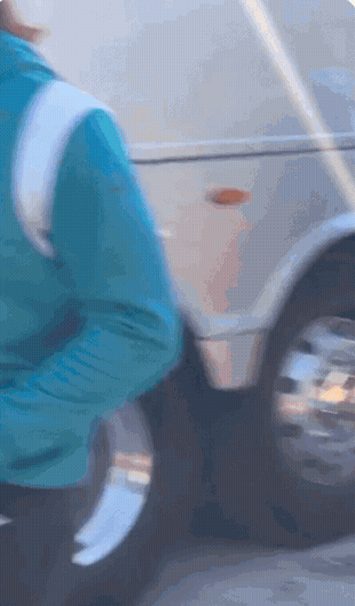 Person In Blue Jacket Next To Silver Vehicle GIF