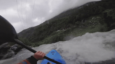 Person In Blue Kayak Paddling Through Rapid GIF