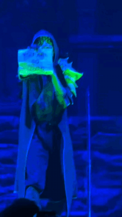 Person In Blue Light Holding I Love You Sign GIF