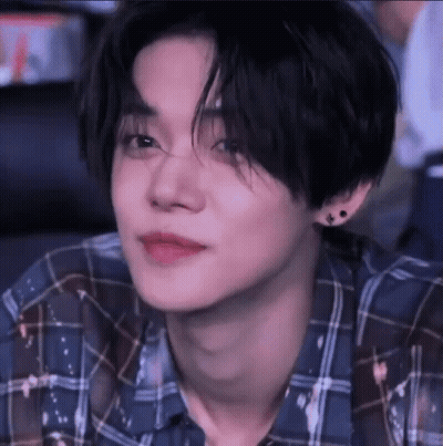Person In Blue Plaid Shirt And Earrings GIF