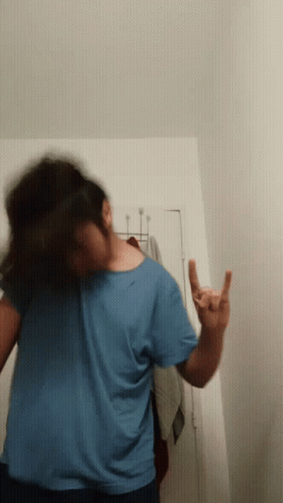 Person In Blue Shirt Giving Horns Sign GIF