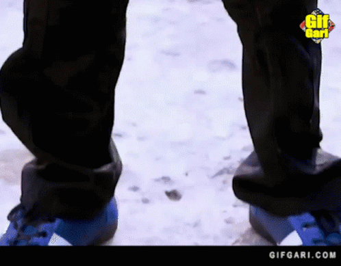 Person In Blue Shoes Standing In Snow GIF