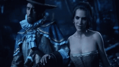Person In Blue Suit Holding Gun In Dark Room GIF