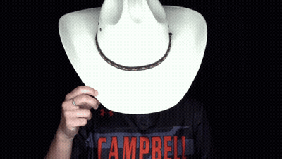 Person In Campbell Shirt Holding Cowboy Hat Over Face GIF