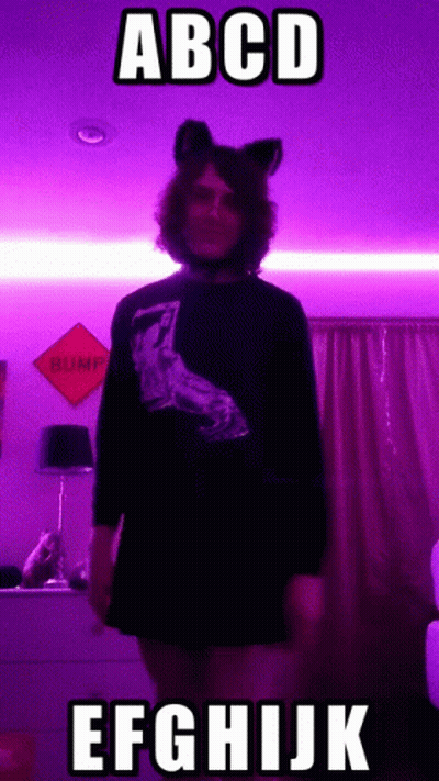 Person In Cat Ear Headband By Purple Wall Saying Bump GIF