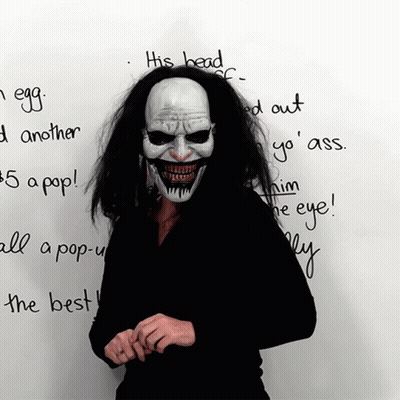 Person In Clown Mask Standing Before Whiteboard GIF