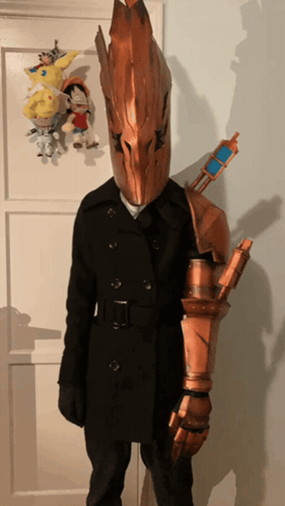 Person In Costume With Helmet And Sword On Arm GIF