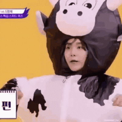 Person In Cow Costume Holding Notebook GIF