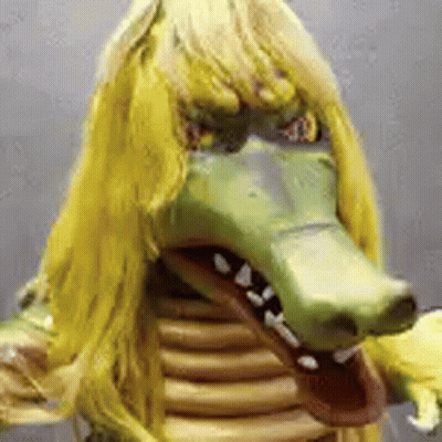 Person In Crocodile Mask With Yellow Hair GIF