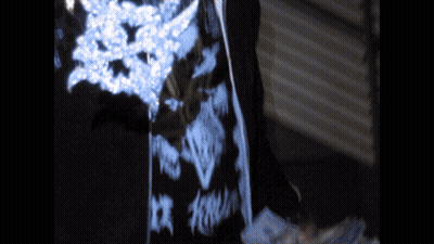 Person In Dark Room With Blue And White Pattern GIF