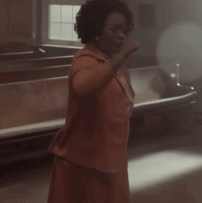 Person In Dark Room With Light Through Ceiling GIF