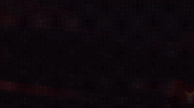 Person In Dark Room With Yellow Arrows GIF