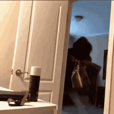 Person In Doorway With Deodorant Can On Table GIF