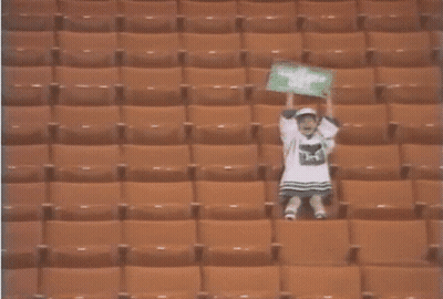 Person In Empty Stadium With H On Shirt GIF