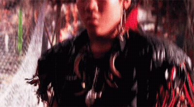 Person In Feathered Jacket And Earrings GIF