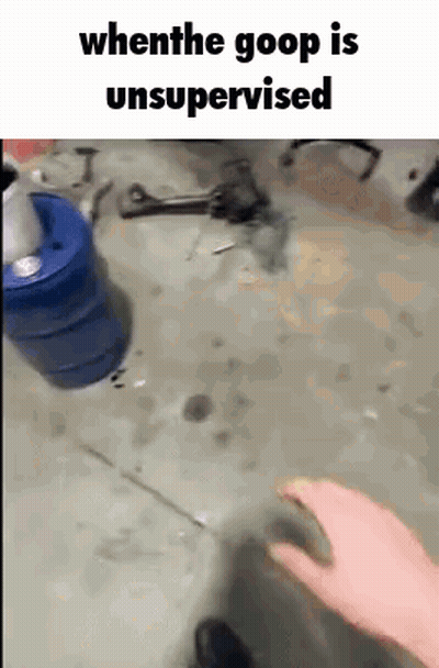 Person In Garage With Blue Bucket And Wrench GIF