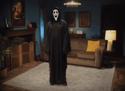Person In Ghost Costume Standing In Living Room GIF